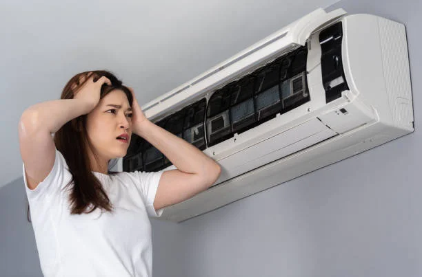A person is worried about how to clean the air conditioner filter